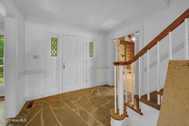 entryway featuring stairway, plenty of natural light, crown molding, and baseboards