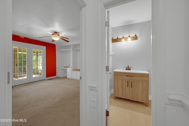 bathroom featuring a ceiling fan, french doors, and vanity