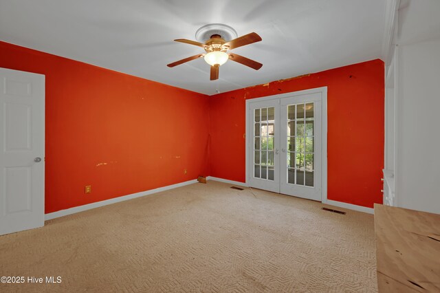 spare room featuring french doors, ceiling fan, baseboards, and carpet floors