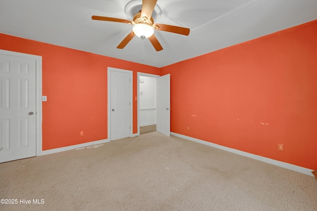 unfurnished bedroom featuring carpet flooring, baseboards, and a ceiling fan