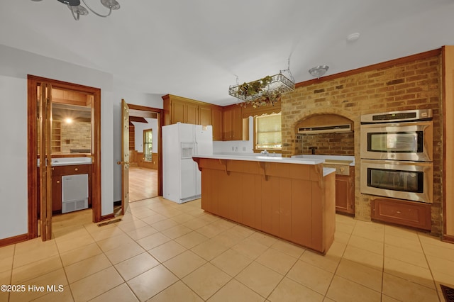 kitchen featuring white refrigerator with ice dispenser, stainless steel double oven, light countertops, light tile patterned floors, and a center island