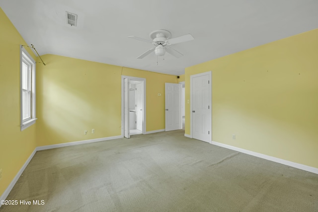 unfurnished bedroom with baseboards, carpet, and lofted ceiling