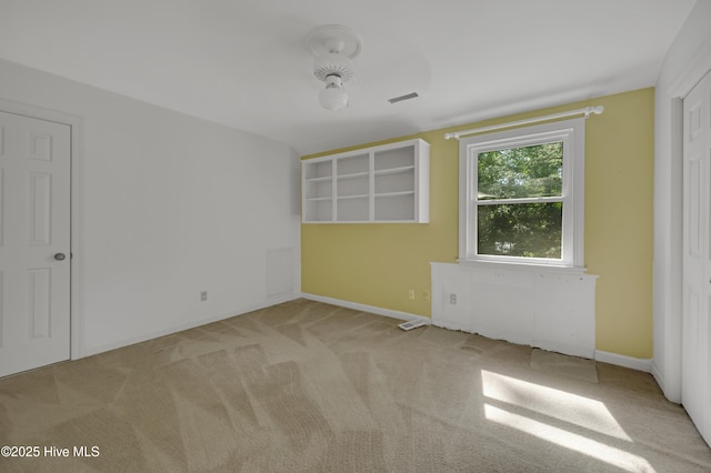 unfurnished room with carpet and baseboards