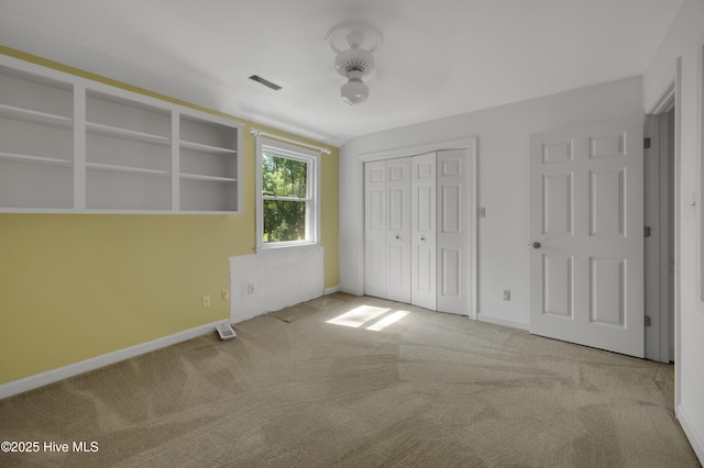 unfurnished bedroom with carpet, baseboards, and a closet