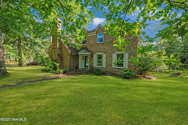 view of front of house featuring brick siding and a front yard