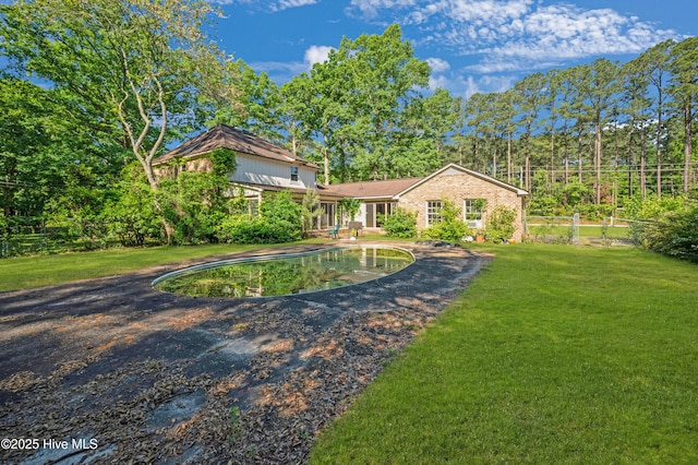view of front facade featuring a front lawn and an outdoor pool
