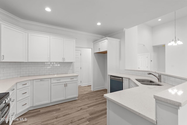 kitchen with a sink, stainless steel appliances, crown molding, decorative backsplash, and white cabinets