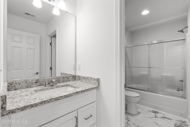 full bath with marble finish floors, toilet, vanity, enclosed tub / shower combo, and recessed lighting
