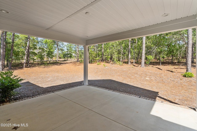 view of patio / terrace with view of wooded area