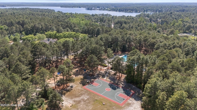 aerial view of a heavily wooded area and a nearby body of water