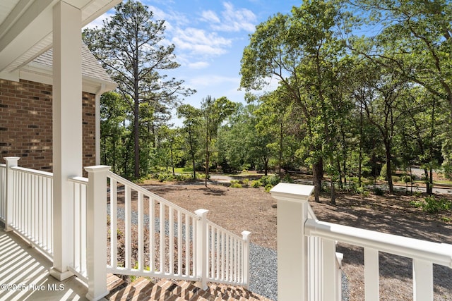 view of yard with view of wooded area and fence