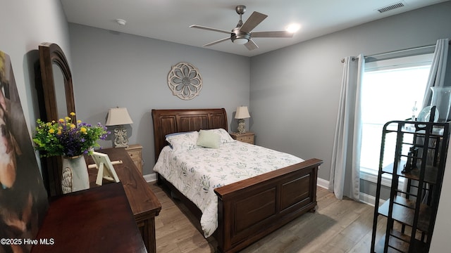 bedroom with multiple windows, light wood-style flooring, and a ceiling fan