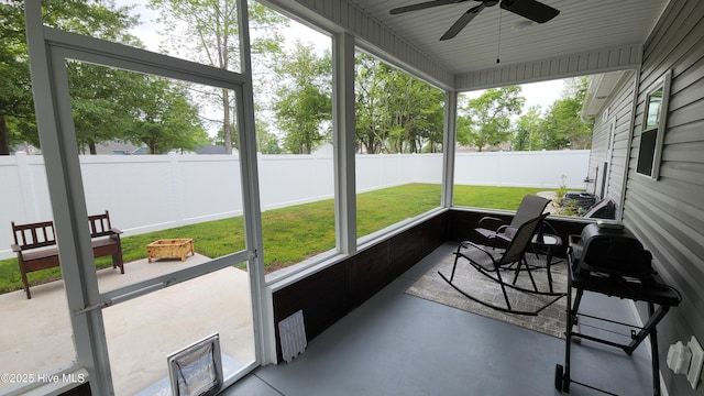 sunroom / solarium featuring ceiling fan