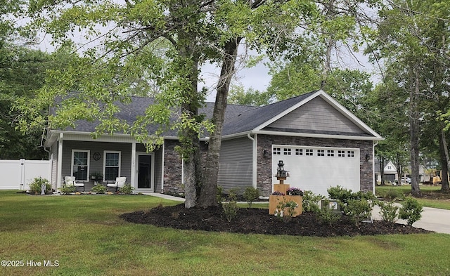 view of front facade featuring a garage, covered porch, driveway, stone siding, and roof with shingles