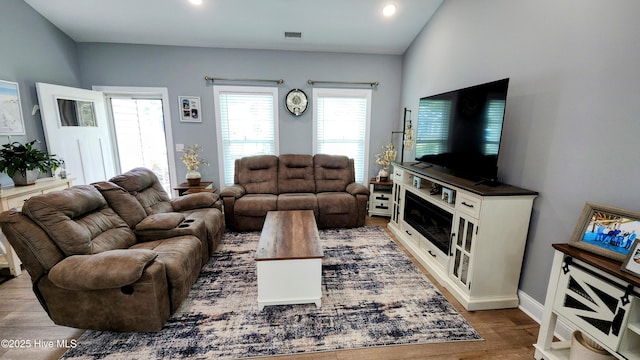 living room featuring wood finished floors, recessed lighting, and baseboards