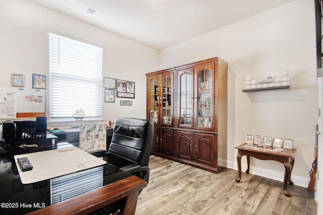 home office featuring light wood-style floors and baseboards