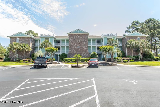 139 Avian Dr Unit 3614, Sunset Beach, NC 28468 - view of building exterior featuring uncovered parking