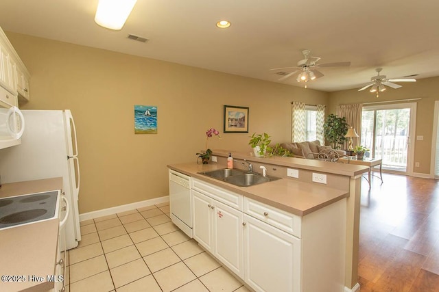 139 Avian Dr Unit 3614, Sunset Beach, NC 28468 - kitchen with a sink, white appliances, open floor plan, a center island with sink, and baseboards