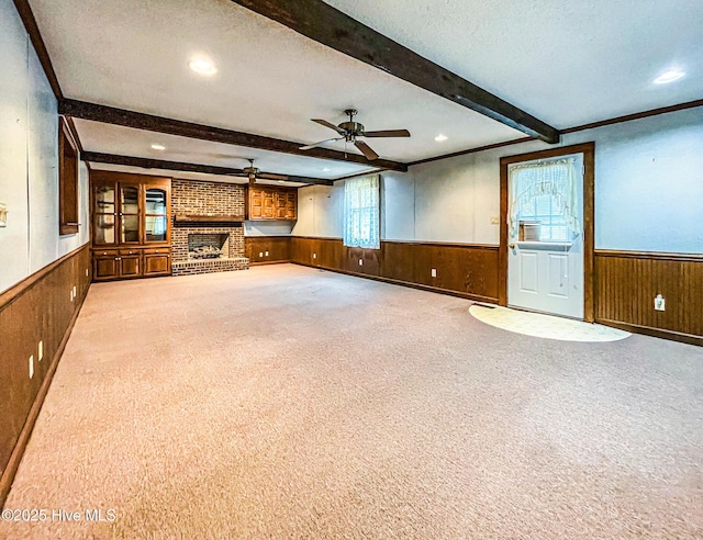 434 Farless Rd, Merry Hill, NC 27957 - unfurnished living room featuring wainscoting, wooden walls, a ceiling fan, beam ceiling, and carpet floors