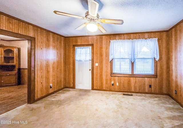 434 Farless Rd, Merry Hill, NC 27957 - unfurnished room featuring wood walls, carpet floors, a ceiling fan, a textured ceiling, and baseboards