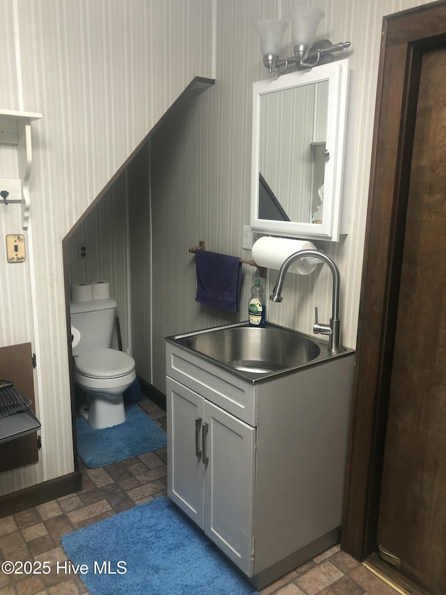 434 Farless Rd, Merry Hill, NC 27957 - bathroom with wallpapered walls, toilet, vanity, and brick patterned floors
