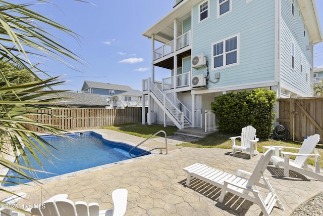 view of swimming pool with ac unit, a fenced backyard, a patio area, and stairs