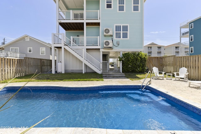 view of pool featuring stairs, a cooling unit, a fenced backyard, and a patio