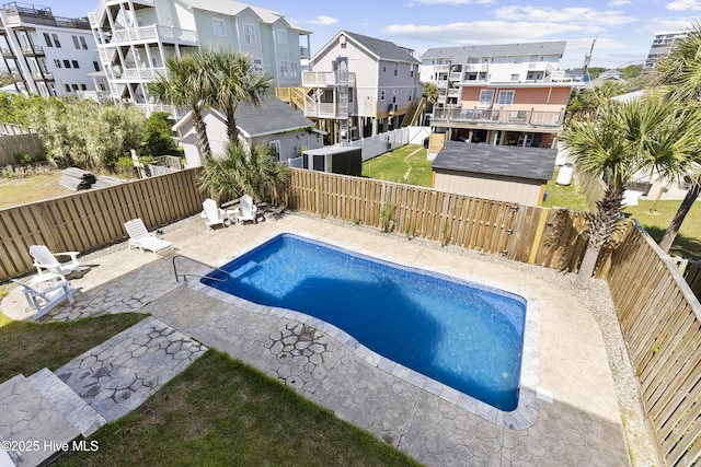 view of swimming pool with a patio area, a residential view, and a fenced backyard