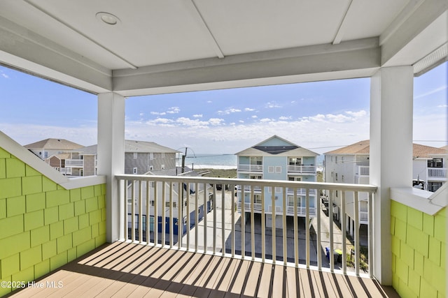 balcony featuring a water view and a residential view