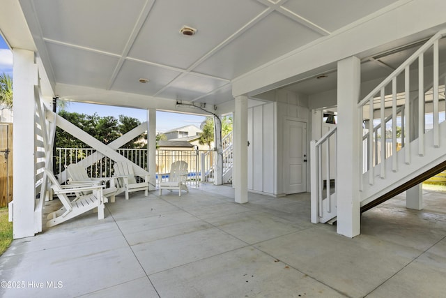 view of patio / terrace featuring stairway and fence