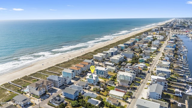 aerial view of property's location featuring waterfront with a beach