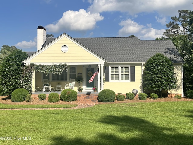 310 N Franklin St, Whiteville, NC 28472 - view of front of property with covered porch, a front yard, a chimney, and roof with shingles