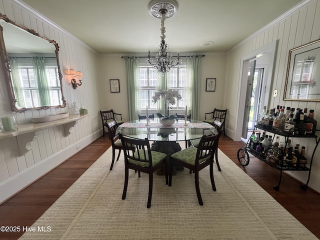310 N Franklin St, Whiteville, NC 28472 - dining area featuring crown molding, a chandelier, wood finished floors, baseboards, and wooden walls