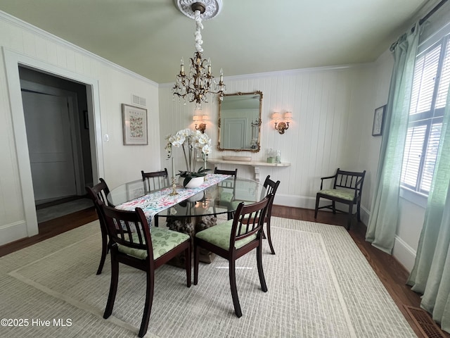 310 N Franklin St, Whiteville, NC 28472 - dining room with a chandelier, wood finished floors, crown molding, and baseboards