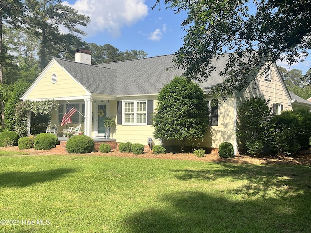 310 N Franklin St, Whiteville, NC 28472 - view of front facade with roof with shingles, a front lawn, a chimney, and covered porch