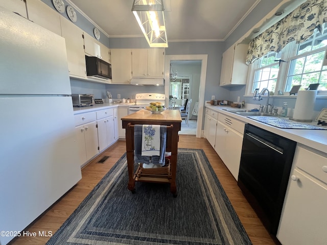 310 N Franklin St, Whiteville, NC 28472 - kitchen with black appliances, wood finished floors, light countertops, crown molding, and a sink