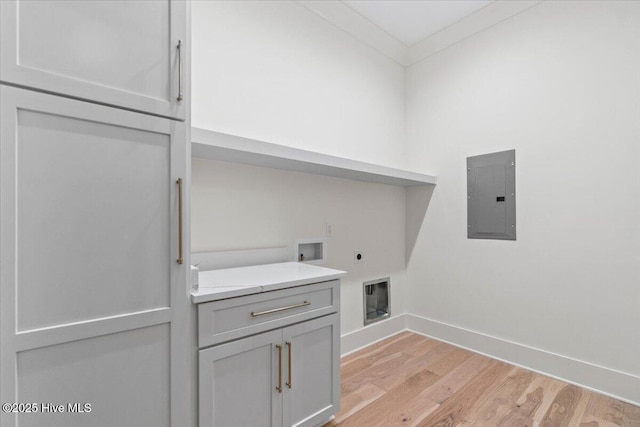 washroom featuring electric panel, hookup for an electric dryer, hookup for a washing machine, light wood-style floors, and baseboards