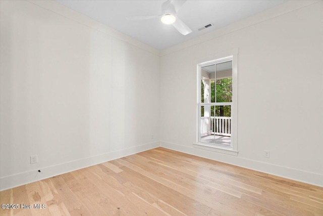 spare room with light wood finished floors, baseboards, and ceiling fan