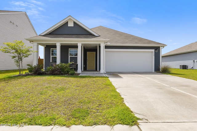3522 Wigeon Way, Winnabow, NC 28479 - view of front of property with an attached garage, a front yard, concrete driveway, central AC unit, and a porch
