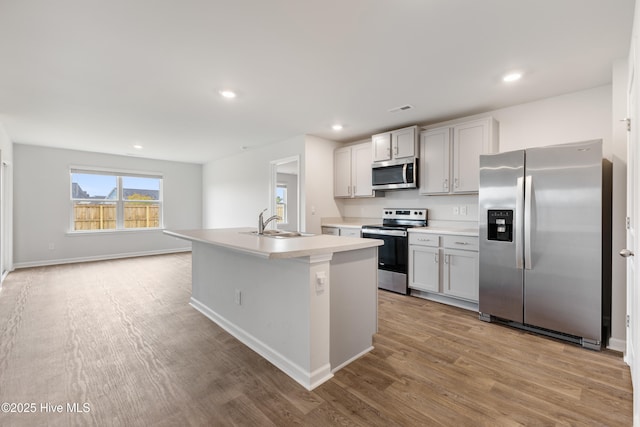 3522 Wigeon Way, Winnabow, NC 28479 - kitchen with stainless steel appliances, wood finished floors, a sink, light countertops, and recessed lighting