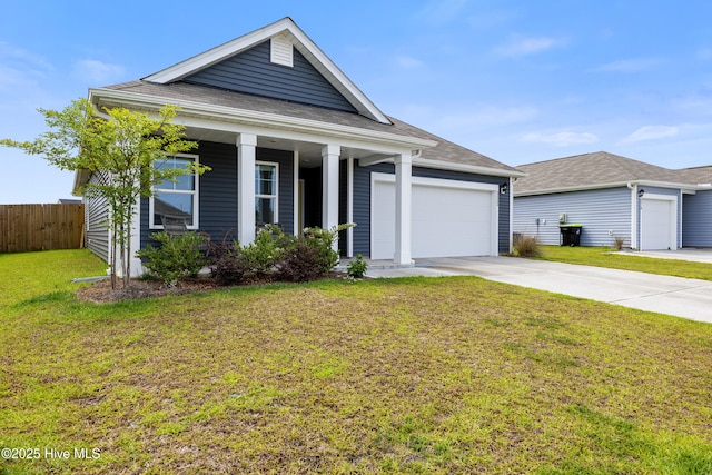 3522 Wigeon Way, Winnabow, NC 28479 - view of front of home with concrete driveway, an attached garage, a shingled roof, and a porch