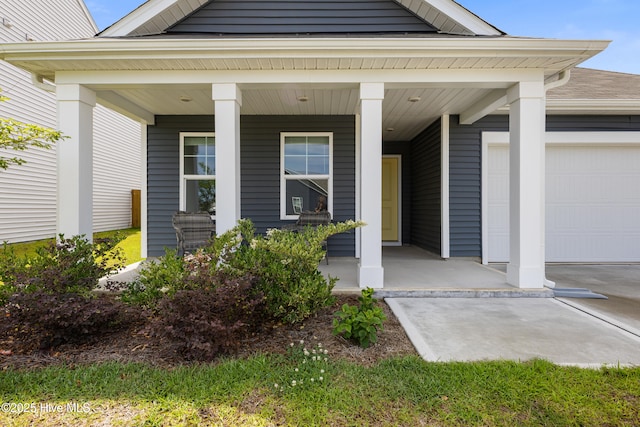 3522 Wigeon Way, Winnabow, NC 28479 - doorway to property featuring a porch and a garage