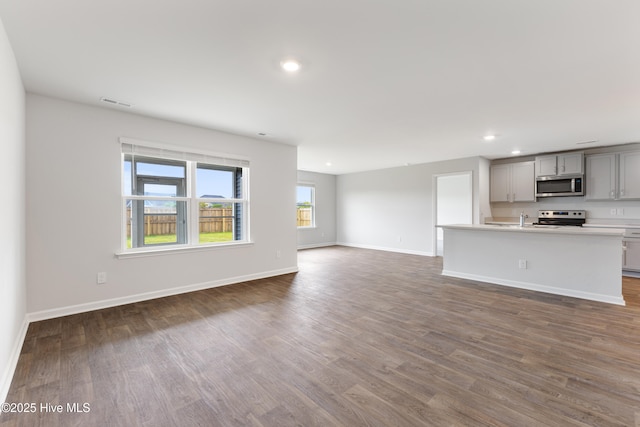 3522 Wigeon Way, Winnabow, NC 28479 - unfurnished living room with dark wood-style flooring, baseboards, and recessed lighting