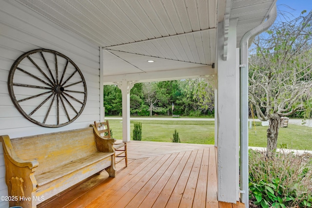 3297 Bay City Rd, Aurora, NC 27806 - wooden terrace featuring a yard, covered porch, and view of wooded area