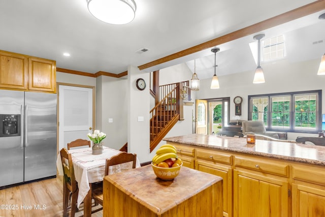 3297 Bay City Rd, Aurora, NC 27806 - kitchen featuring stainless steel fridge, light wood-style floors, open floor plan, a kitchen island, and decorative light fixtures