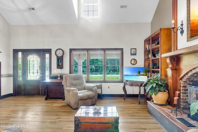 3297 Bay City Rd, Aurora, NC 27806 - living area featuring a high ceiling, light wood-type flooring, plenty of natural light, and baseboards