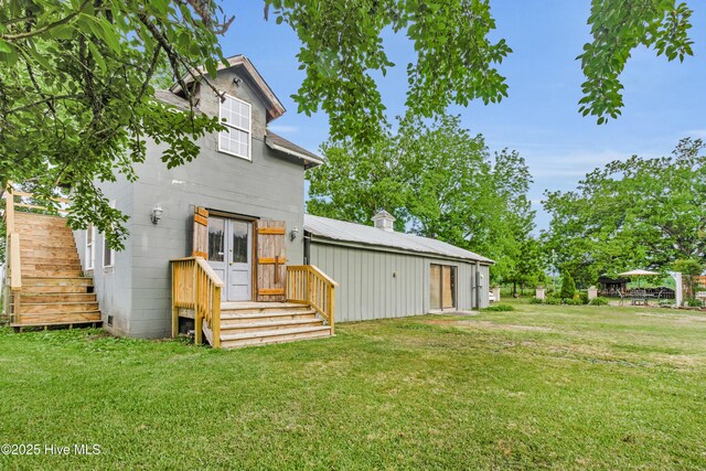 3297 Bay City Rd, Aurora, NC 27806 - rear view of property with french doors, a yard, and concrete block siding