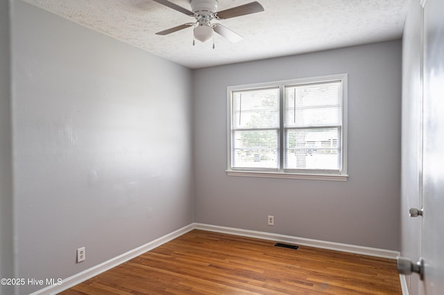 137 Pinecrest Trl, Rockingham, NC 28379 - spare room with baseboards, ceiling fan, wood finished floors, and a textured ceiling