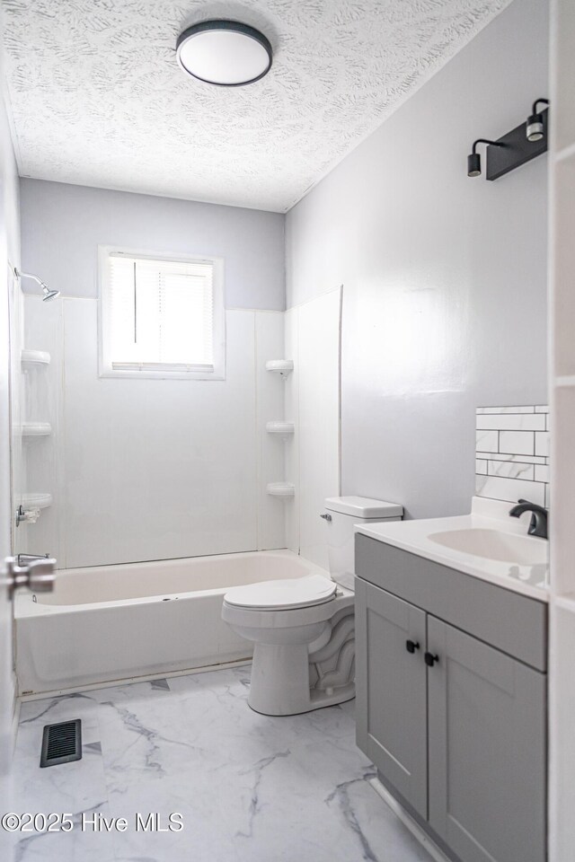137 Pinecrest Trl, Rockingham, NC 28379 - bathroom featuring toilet, shower / washtub combination, marble finish floors, vanity, and a textured ceiling
