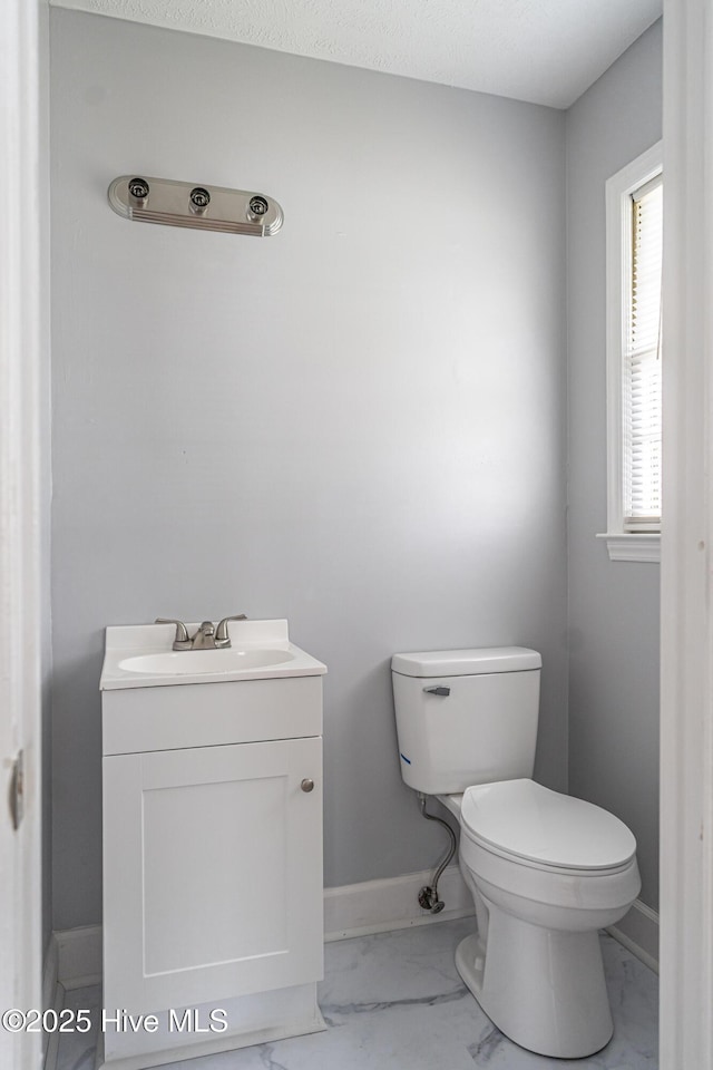137 Pinecrest Trl, Rockingham, NC 28379 - half bath with marble finish flooring, toilet, vanity, and baseboards